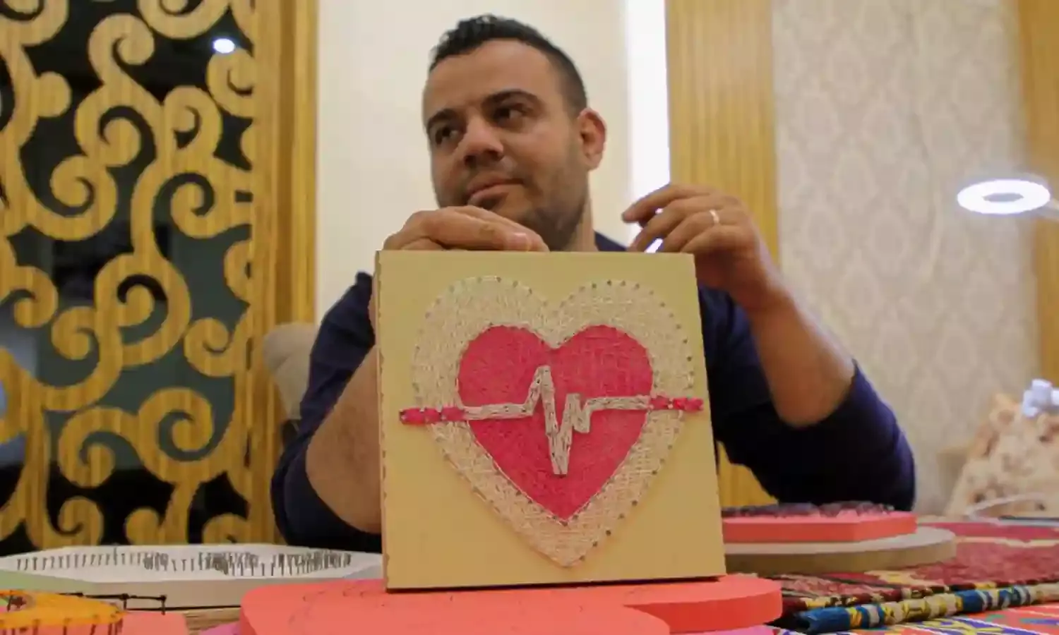 Unemployed Palestinian makes living from using nails, coloured threads for art